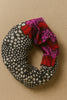 Afrocentric scrunchie with black and white polka dots and bold red, purple floral print