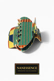 Colorful Afrocentric patterned hair claw clip with geometric and checkered designs on white background.