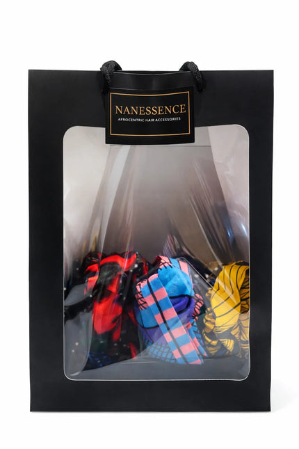 Black gift bag with clear window displaying colorful Afrocentric hair accessories