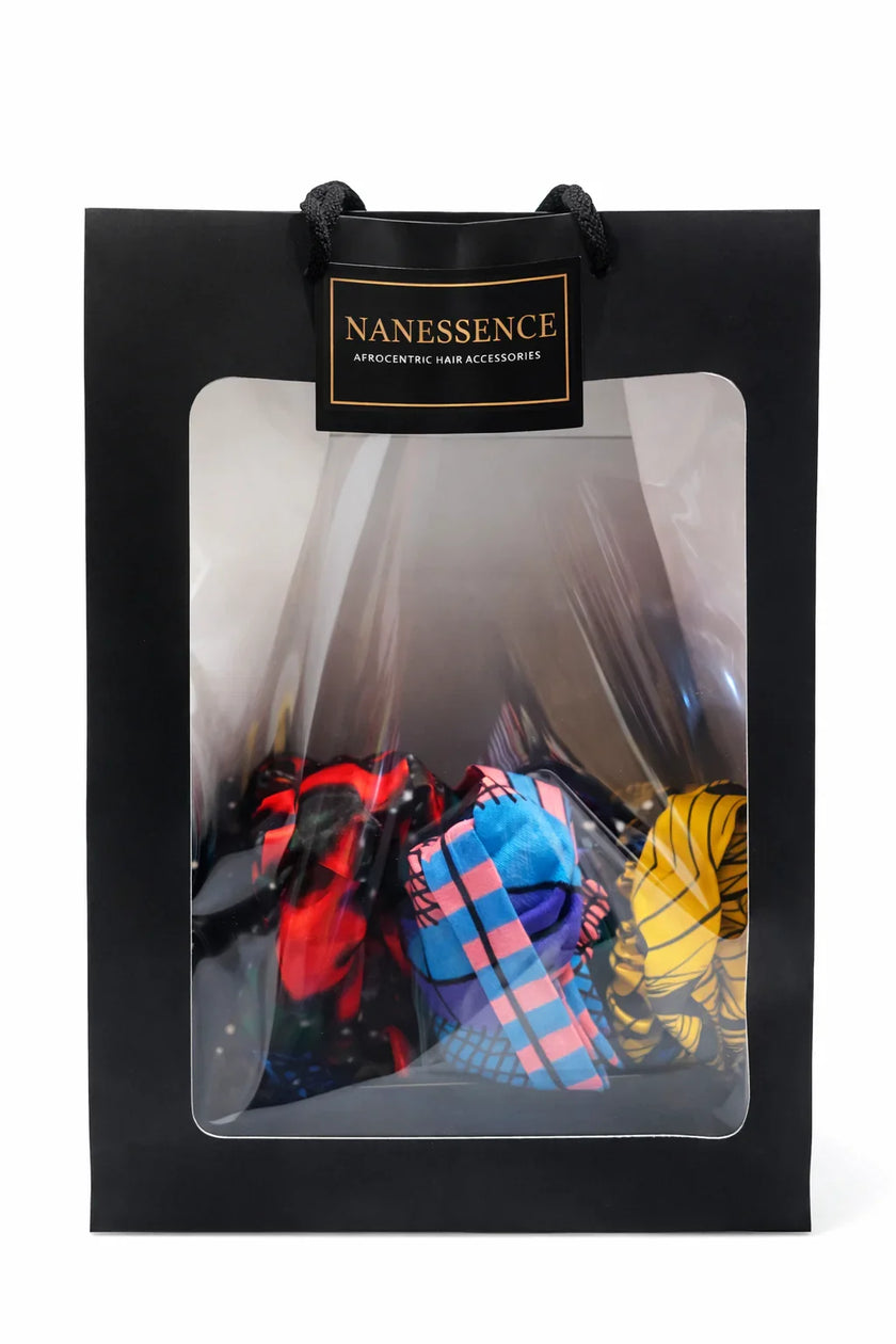 Black gift bag with clear window displaying colorful Afrocentric hair accessories
