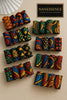 Colorful Afrocentric hair accessories with vibrant geometric and leaf patterns on fabric bows