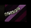 Close-up of purple and black striped fabric with silver decorative accents, Afrocentric accessory