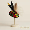 Afrocentric fascinator with bold geometric patterns, black and beige feathers, modern elegance